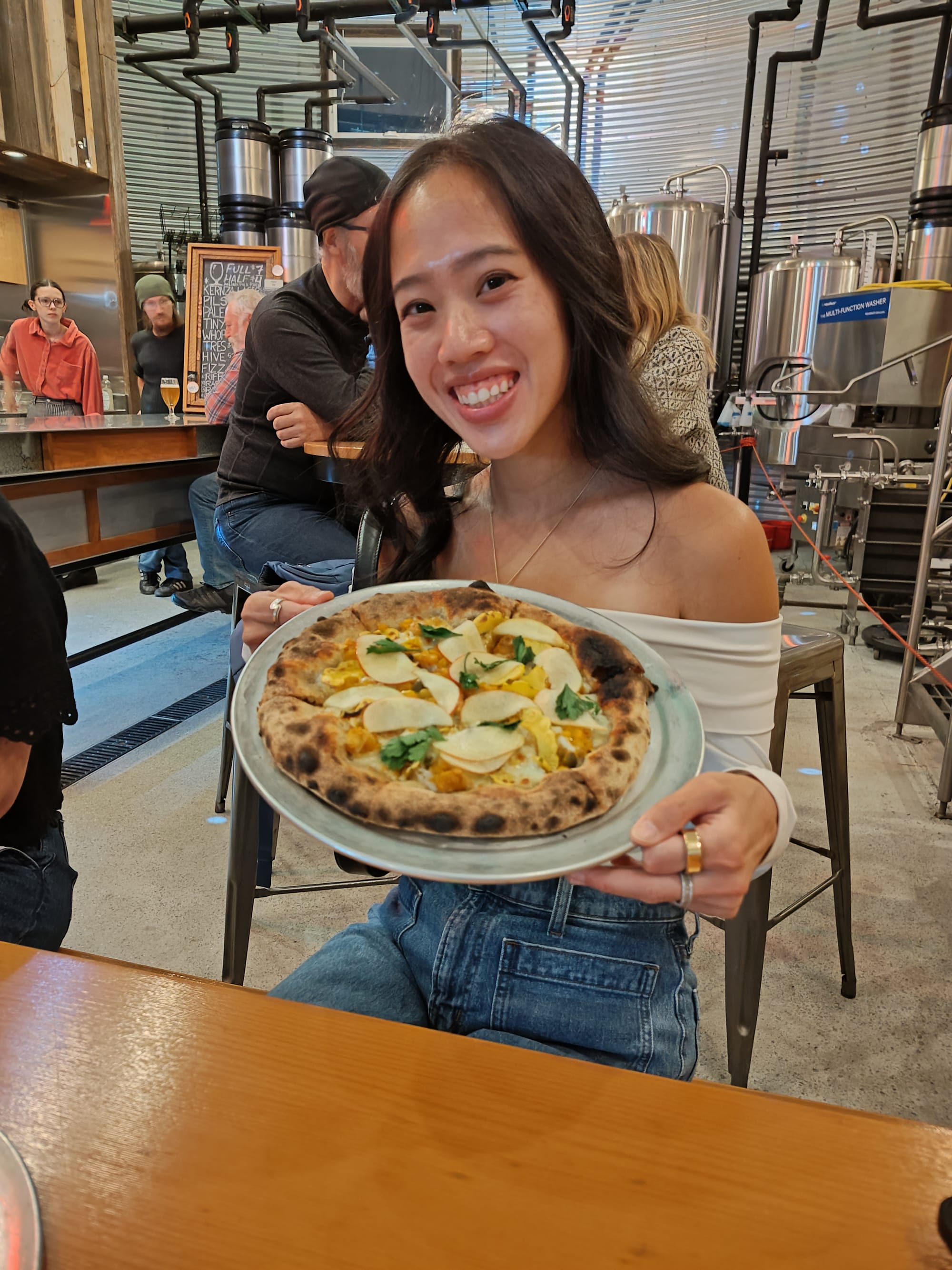 girl holding an apple pizza