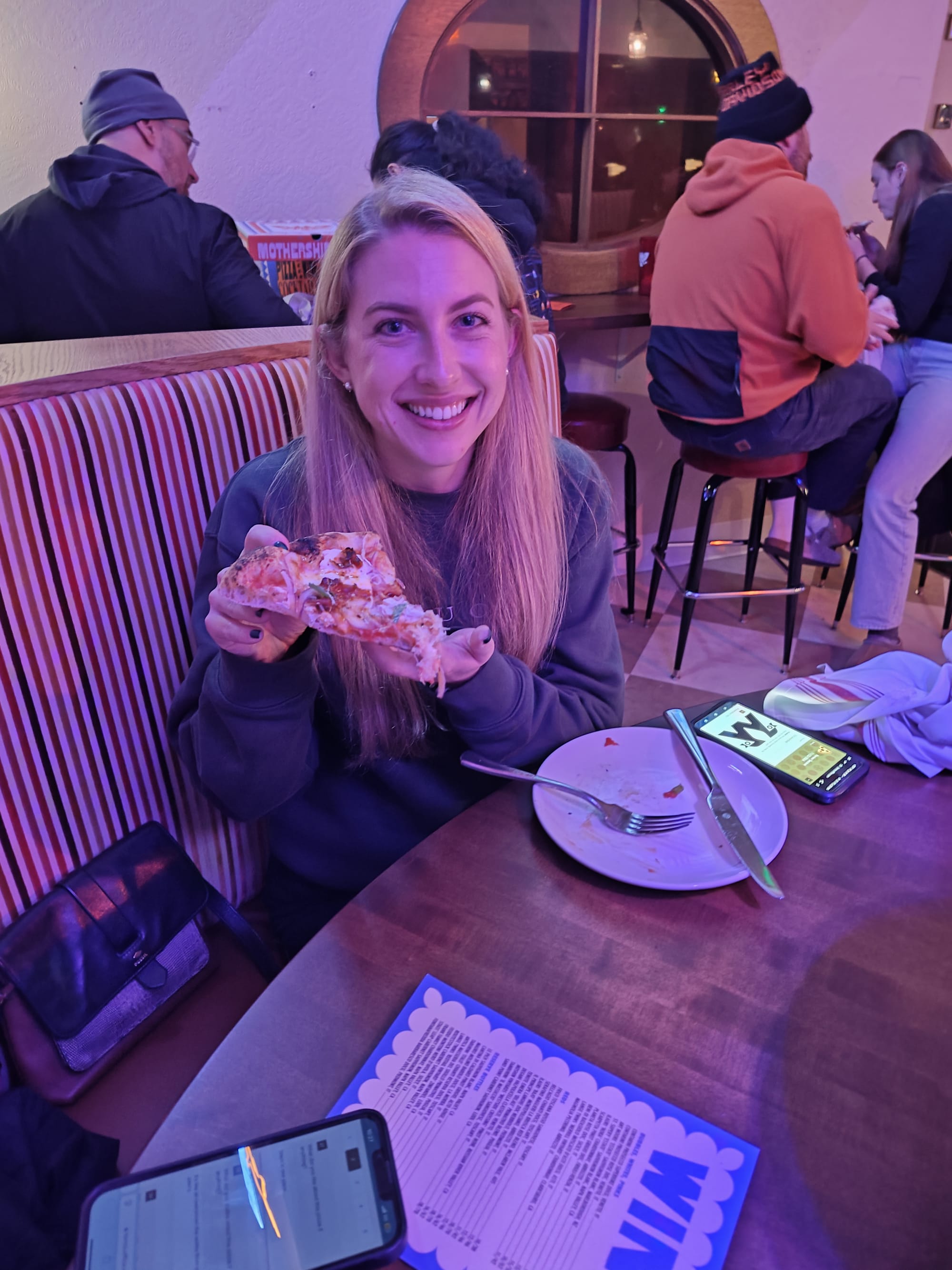 woman holding pizza