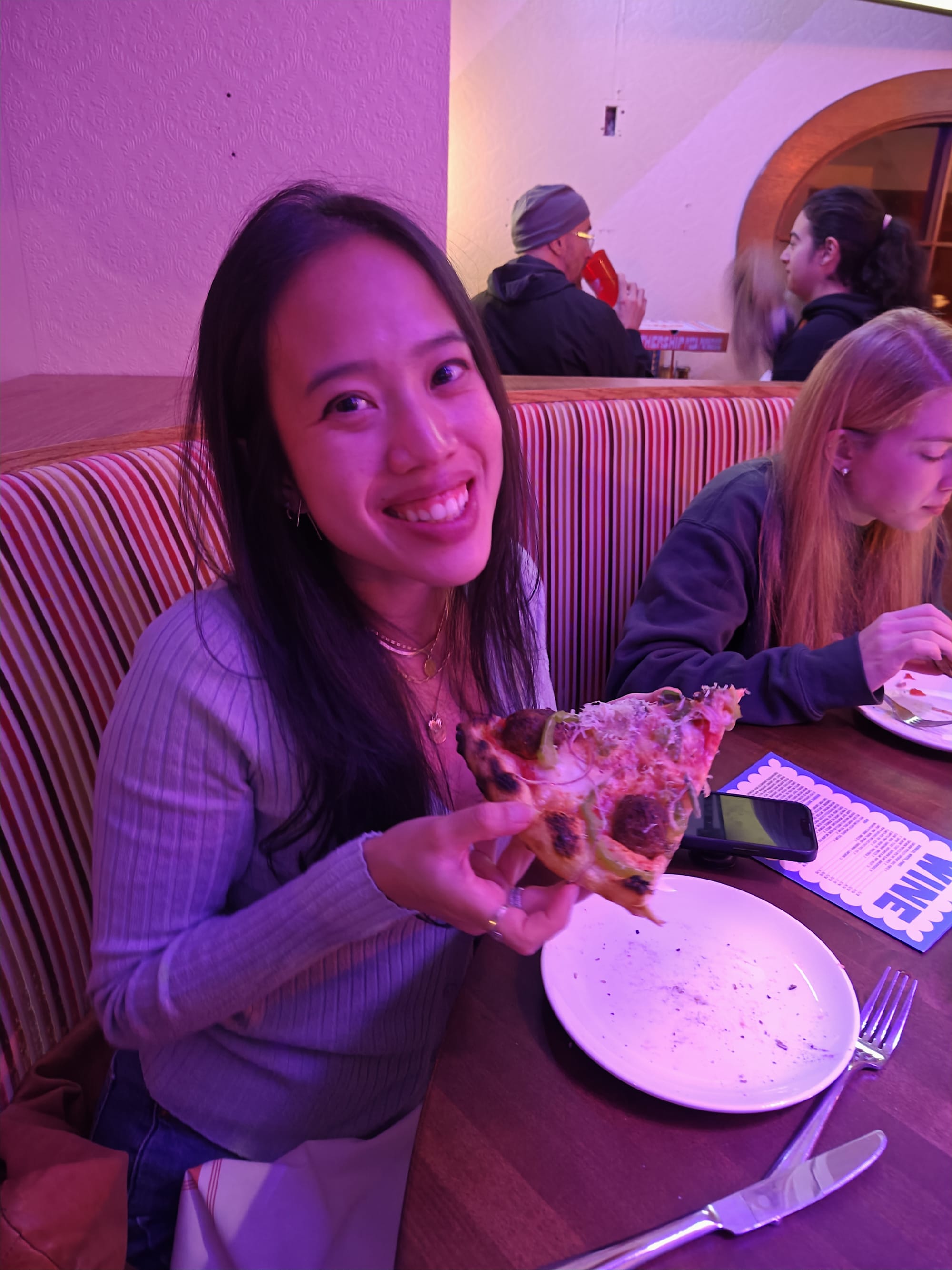 woman holding pizza