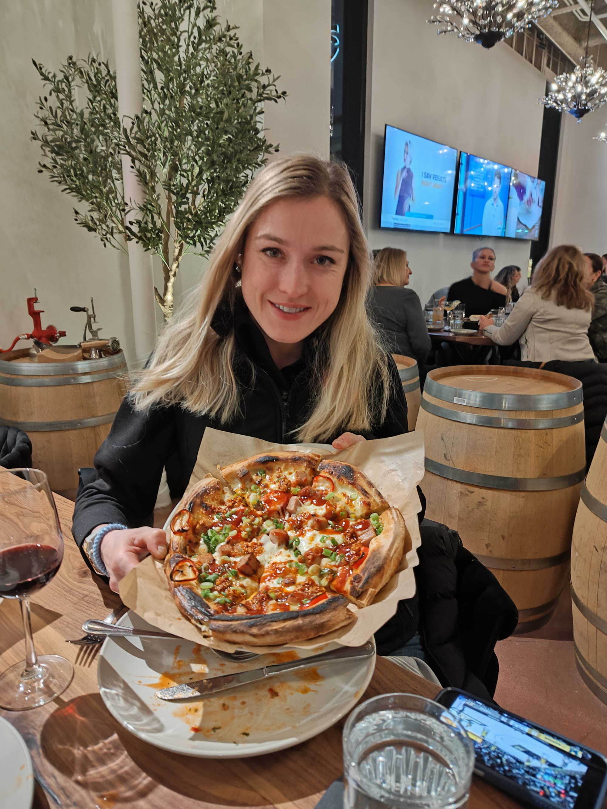 woman holding a spicy pizza