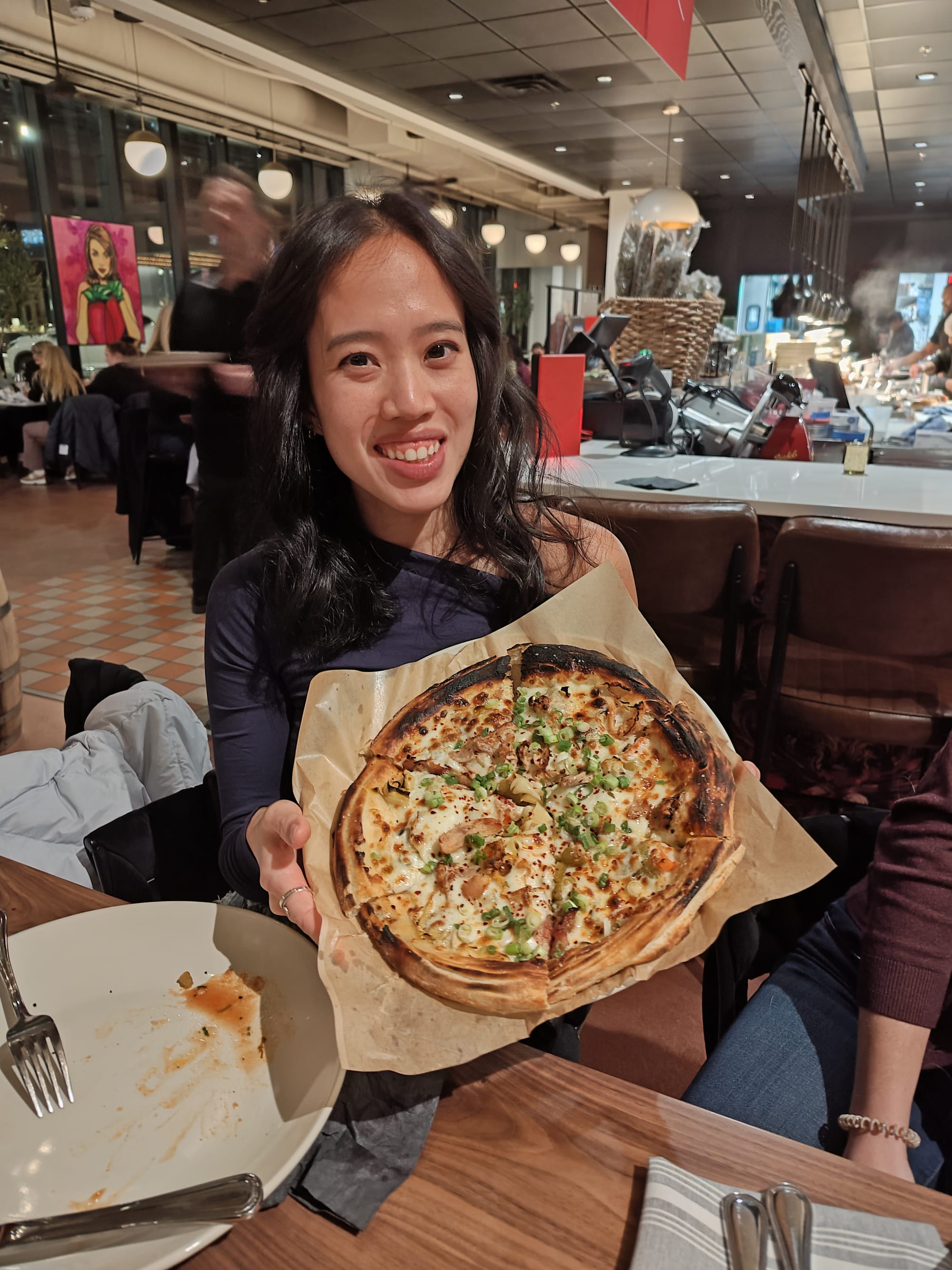 woman holding a pizza